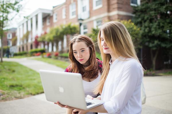 Students outdoors on laptop