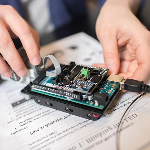 Engineering student works on miniature robot